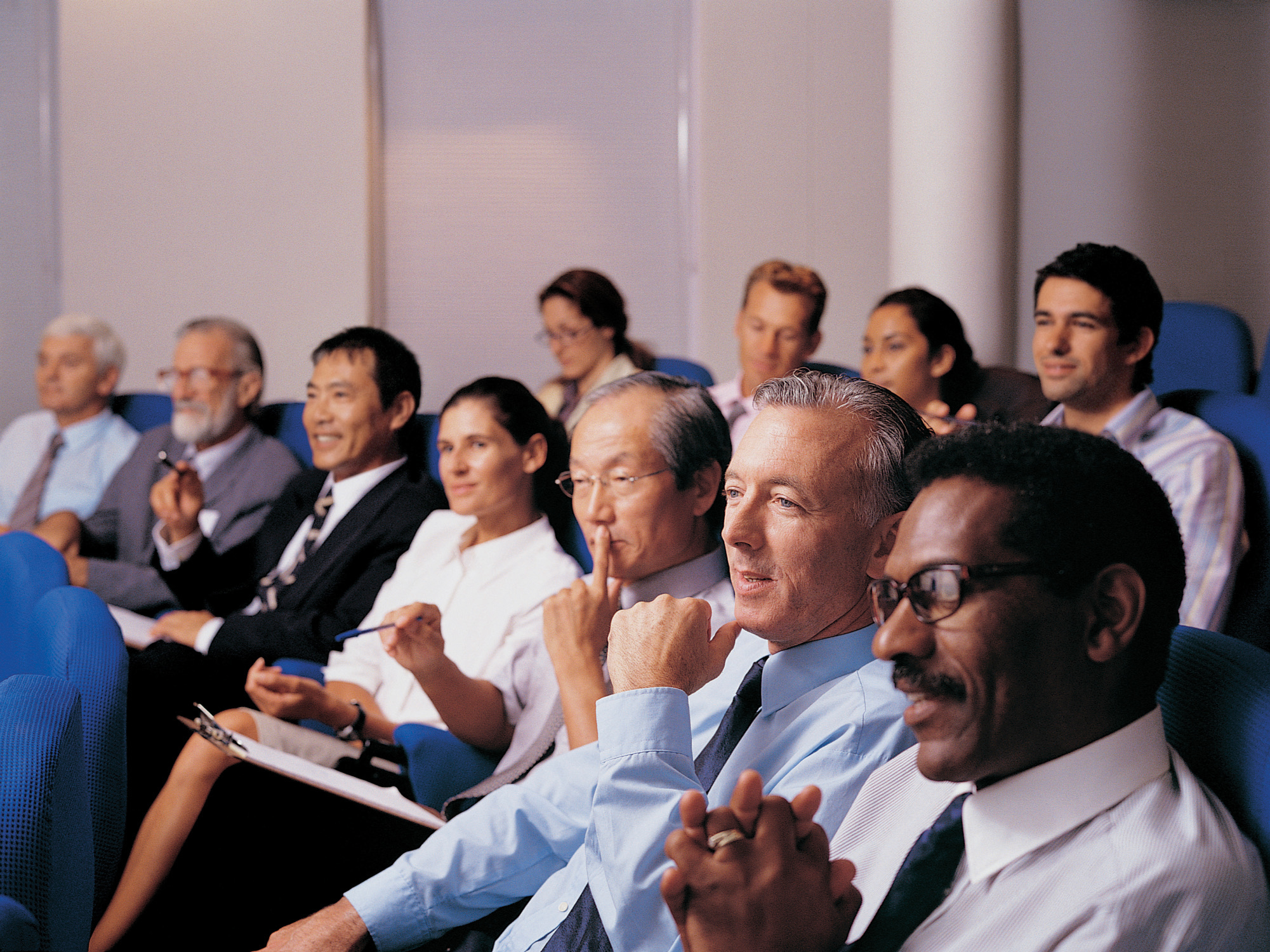 Photo of people seated and listening to a speaker